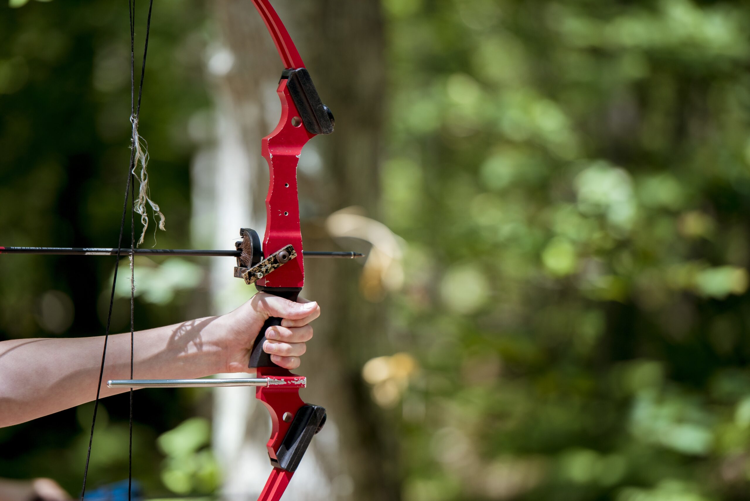 closeup-shot-person-holding-up-bow-arrow-scaled.jpg